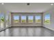Bright living room with wood floors and large windows offering scenic views at 814 Manns Harbor Dr, Apollo Beach, FL 33572