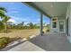 A covered patio with brick flooring overlooks the lush backyard at 814 Manns Harbor Dr, Apollo Beach, FL 33572