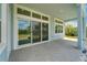 Covered outdoor patio boasts stone flooring, a large sliding glass door and is perfect for entertaining guests at 814 Manns Harbor Dr, Apollo Beach, FL 33572