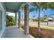 Charming porch featuring stone pillars, gray pavers, and colorful landscaping at 814 Manns Harbor Dr, Apollo Beach, FL 33572