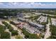 Aerial view of commercial buildings with shops, restaurants, parking and roads with trees, and greenery at 9106 Crystal Commons Way, Tampa, FL 33626