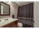 Neutral bathroom showcasing a dark wood vanity and shower with decorative curtain at 9106 Crystal Commons Way, Tampa, FL 33626