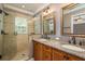 Bathroom featuring double sinks, granite countertops, a glass-enclosed shower, and stylish fixtures at 9106 Crystal Commons Way, Tampa, FL 33626