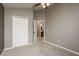 A neutral bedroom shows a closet and door to the bathroom with a raised ceiling at 9106 Crystal Commons Way, Tampa, FL 33626