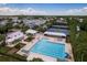 Aerial view of a community pool and tennis courts surrounded by lush landscaping and residential homes at 9106 Crystal Commons Way, Tampa, FL 33626