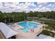 An aerial view of a community pool, a waterslide, and lounge chairs, perfect for summer relaxation at 9106 Crystal Commons Way, Tampa, FL 33626