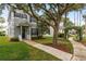 Charming two-story home with blue shutters, a covered porch, and mature trees adding curb appeal at 9106 Crystal Commons Way, Tampa, FL 33626