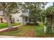 The two-story home boasts a charming front exterior, landscaped yard, and an inviting walkway at 9106 Crystal Commons Way, Tampa, FL 33626