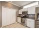 The kitchen boasts stainless steel appliances, ample cabinet space, tile flooring, and an adjacent pantry at 9106 Crystal Commons Way, Tampa, FL 33626