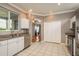 Bright kitchen features tile floors, white cabinets, stainless steel appliances, and access to the living area at 9106 Crystal Commons Way, Tampa, FL 33626