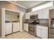 The kitchen features a laundry closet with a washer and dryer, adding convenience to daily chores at 9106 Crystal Commons Way, Tampa, FL 33626