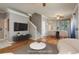 Bright living room with hardwood floors, a ceiling fan, stairs, and dining area with sliding glass doors at 9106 Crystal Commons Way, Tampa, FL 33626