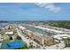 Aerial view of coastal community with condos, boat docks, pool, and tennis courts on a sunny day at 1 Boca Ciega Point Blvd # 212, St Petersburg, FL 33708