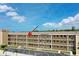 Low-rise condo building featuring well-maintained balconies and ample parking under a bright sky at 1 Boca Ciega Point Blvd # 212, St Petersburg, FL 33708