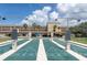 Community shuffleboard courts in front of condominiums with solar-powered lighting for evening games at 1 Boca Ciega Point Blvd # 212, St Petersburg, FL 33708