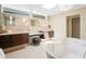 Elegant bathroom with double vanity, a soaking tub, and modern fixtures and lighting at 10 Brightwaters Ne Cir, St Petersburg, FL 33704