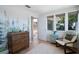 Comfortable Bedroom featuring a dresser, chair, and picturesque view with a mural of coniferous trees on the wall at 10 Brightwaters Ne Cir, St Petersburg, FL 33704