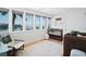 Bedroom with multiple windows overlooking water, light floors, a crib, and soft accent colors at 10 Brightwaters Ne Cir, St Petersburg, FL 33704