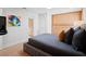 Modern bedroom featuring a large bed, built-in closet and drawer system, and colorful artwork at 10 Brightwaters Ne Cir, St Petersburg, FL 33704