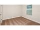 This bedroom has neutral walls, a window, base molding, and brown carpeting at 10025 Surrey Rose Dr, San Antonio, FL 33576