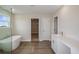 Modern bathroom with a soaking tub, separate shower, double sink vanity, and walk-in closet at 10037 Surrey Rose Dr, San Antonio, FL 33576