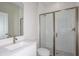 Modern bathroom featuring a glass-enclosed shower, white vanity with quartz countertop, and stylish fixtures at 10037 Surrey Rose Dr, San Antonio, FL 33576