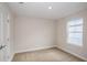Neutral bedroom with a door and a window providing natural light and neighborhood views at 10037 Surrey Rose Dr, San Antonio, FL 33576