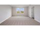 Spacious bedroom with two windows and neutral carpeting, offering a peaceful retreat at 10037 Surrey Rose Dr, San Antonio, FL 33576
