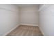Walk-in closet with shelving and carpet, ready for organized storage solutions at 10037 Surrey Rose Dr, San Antonio, FL 33576
