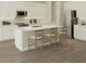 Bright kitchen boasts white cabinets, stainless steel appliances, and a spacious center island with seating at 10037 Surrey Rose Dr, San Antonio, FL 33576