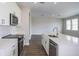 Bright kitchen with stainless steel appliances and a view into an open floorplan at 10037 Surrey Rose Dr, San Antonio, FL 33576