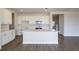 Contemporary kitchen featuring white cabinets, stainless steel appliances, and center island at 10037 Surrey Rose Dr, San Antonio, FL 33576