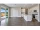 Open concept kitchen with white cabinets, a center island and stainless steel appliances at 10037 Surrey Rose Dr, San Antonio, FL 33576