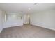 Open living area with neutral carpeting, white walls, and ample space for entertaining or relaxing at 10037 Surrey Rose Dr, San Antonio, FL 33576