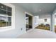 Covered patio offering outdoor living space with a view of the yard and neighboring homes at 10037 Surrey Rose Dr, San Antonio, FL 33576
