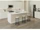 Bright, open kitchen with stainless steel appliances, a large island, and modern white cabinetry at 10243 Fieldstone Myrtle Way, San Antonio, FL 33576