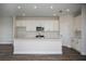 Modern kitchen with white cabinets, stainless steel appliances, and a large center island at 10243 Fieldstone Myrtle Way, San Antonio, FL 33576
