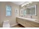Contemporary bathroom featuring a double vanity, illuminated mirror, and modern fixtures at 10884 118Th St, Seminole, FL 33778