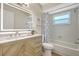 Updated bathroom with a modern vanity, stylish lighting and a shower-tub combo at 10884 118Th St, Seminole, FL 33778
