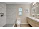 Modern bathroom with tiled shower, floating vanity, and contemporary fixtures at 10884 118Th St, Seminole, FL 33778