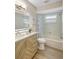 Renovated bathroom features a modern vanity, stylish lighting and a shower-tub combo at 10884 118Th St, Seminole, FL 33778