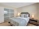 Bright bedroom featuring a sliding closet door and a well-appointed bed at 10884 118Th St, Seminole, FL 33778