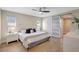 Spacious bedroom with ceiling fan, modern decor, and a sliding door to the bathroom at 10884 118Th St, Seminole, FL 33778