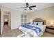Cozy bedroom features wood floors, a ceiling fan and an ensuite at 10884 118Th St, Seminole, FL 33778