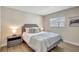 Cozy bedroom with a comfortable bed, stylish side tables, and wood flooring at 10884 118Th St, Seminole, FL 33778