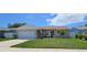 Beautiful single-Gathering home featuring a well-kept lawn, attached garage, and a cozy front porch seating area at 10884 118Th St, Seminole, FL 33778