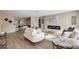 Inviting living room with sleek fireplace, modern furnishings, and wood-look floors at 10884 118Th St, Seminole, FL 33778