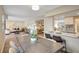 Open-concept layout features a living room and dining area, complemented by ample natural light and wood flooring at 10884 118Th St, Seminole, FL 33778