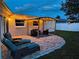 Inviting outdoor patio with a pergola, comfortable seating, and ambient lighting at 10884 118Th St, Seminole, FL 33778