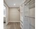 Well-organized walk-in closet with shelving and hanging space, leading to a bathroom at 10884 118Th St, Seminole, FL 33778